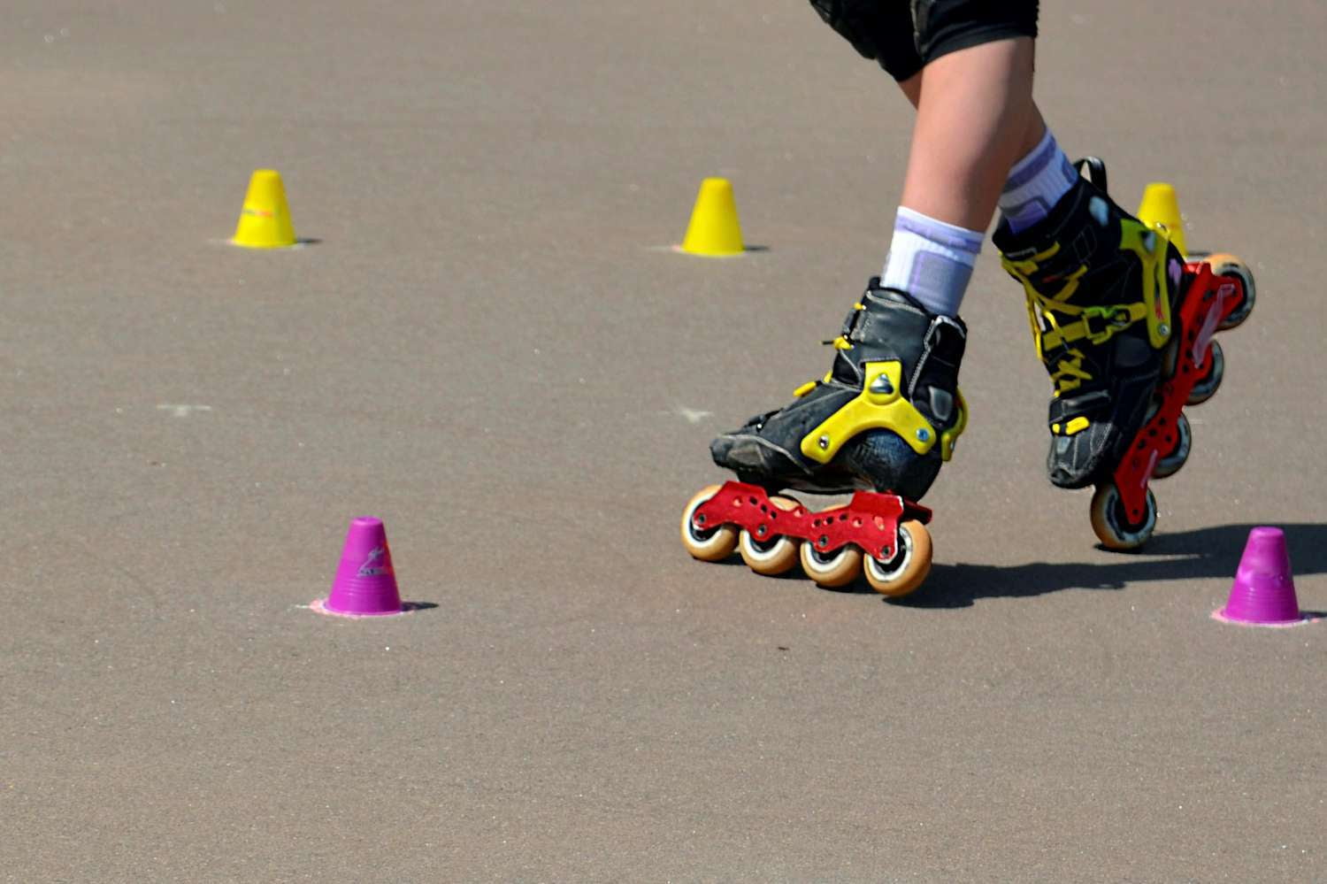 Inline skater practising between colourful cones